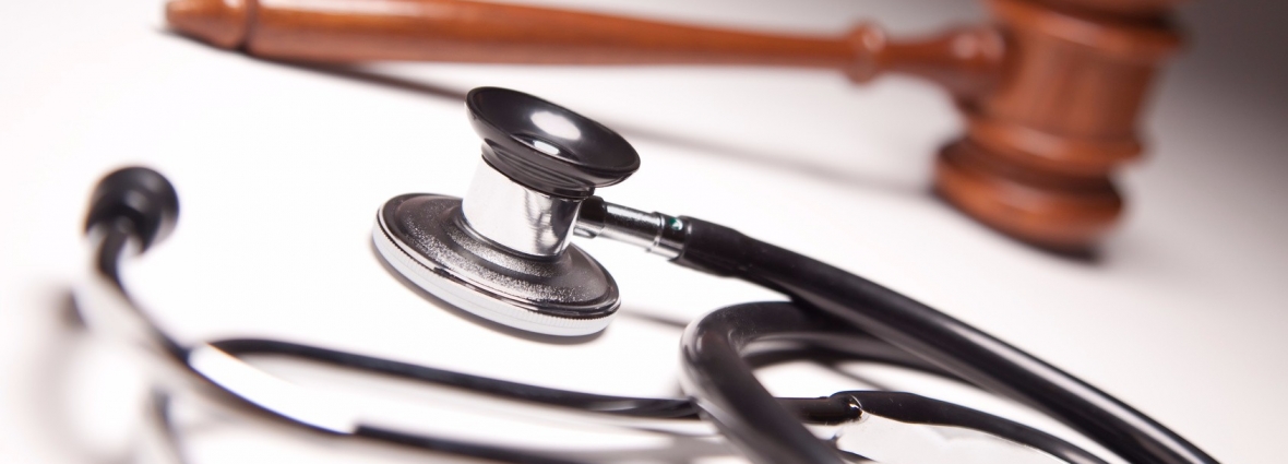 Gavel and Stethoscope on Gradated Background with Selective Focus.